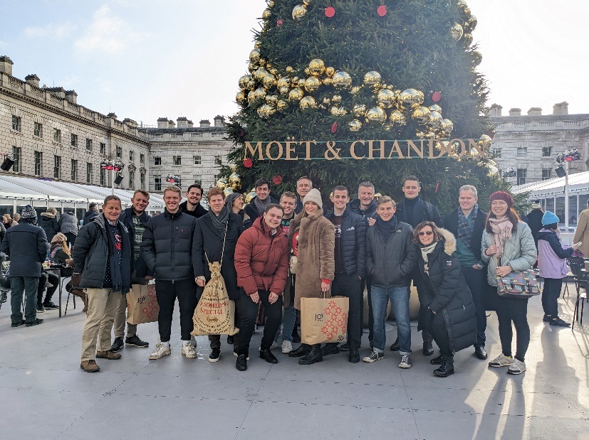 Silverpeak team members standing in front of a Christmas tree in a city square